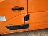 an orange van that has been vandalized with a sticker on it