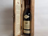 an open wooden box with a bottle of wine inside of it