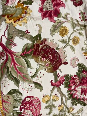 a close up of a bed with a floral pattern on it