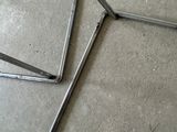 two pieces of metal sitting on the floor next to each other