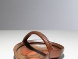 brown leather handbag with handle on white surface