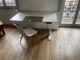 a white desk with a chair in front of a window