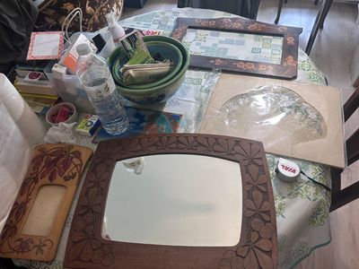 a table that has a mirror on it and many other items on the table
