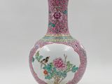 an image of a pink and white vase with a bird on it