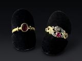 a pair of gold rings with ruby stones and diamonds