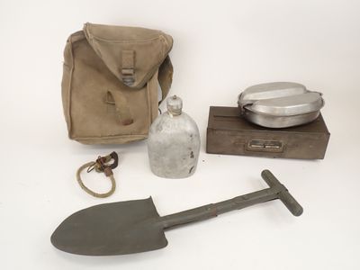 a shovel, a bottle, and a bag on a table