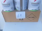 three cans of paint sitting on top of a cardboard box
