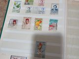 an open book with stamps on it sitting on a table