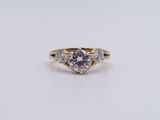 a yellow gold engagement ring with a round brilliant cut diamond