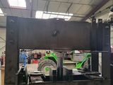 a picture of a machine that is working on a piece of metal