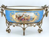 a blue bowl with a painting on it sitting on a stand
