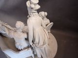 a statue of a man riding a horse with a woman on it