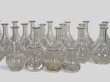 a lot of glass vases that are lined up together