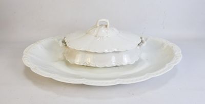 a white plate with a lid on it on a white table