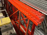 a long metal shelf with a lot of metal items on it