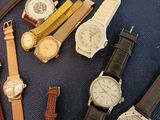 a lot of watches that are sitting on a table