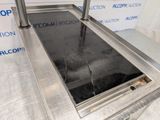 a stainless steel counter top with a glass window
