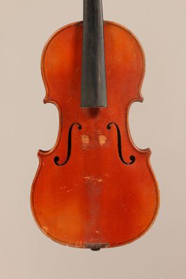 an old violin with a bow hanging from the back