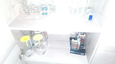 a shelf that has a bunch of glasses on top of it