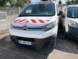 a white van with a red stripe parked next to a white van