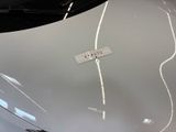 a sticker on the hood of a white car