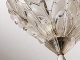a glass chandelier hanging from the ceiling in a room