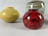 three vases sitting next to each other on a table