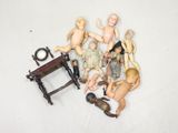 a lot of dolls that are sitting on a table