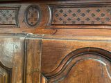 a large wooden cabinet with a mirror on top of it