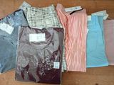 a lot of shirts that are on a table