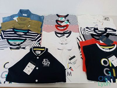a lot of t - shirts that are on a table