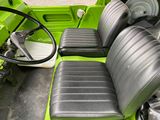 an image of a green car with black seats and steering wheel