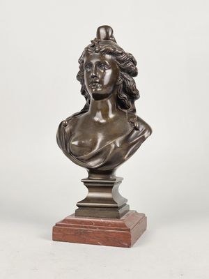 a bronze bust of a woman on a wooden base