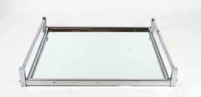 a metal tray with a mirror on top of it on a white surface