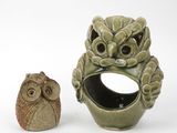 a ceramic owl and a ceramic owl figurine on a white background