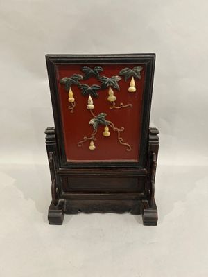 an image of a small wooden frame with bells on it