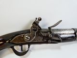 an old gun that is on display on a table
