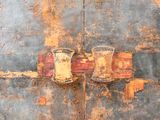 a rusted wall with a rusted door and a rusted door handle
