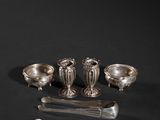 an assortment of silverware on a black background with a knife and spoon