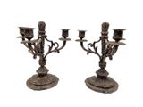 pair of antique brass candelabs with candles on stands