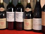 several bottles of wine are lined up in a row on a table