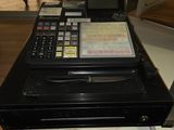 a cash register sitting on top of a glass shelf