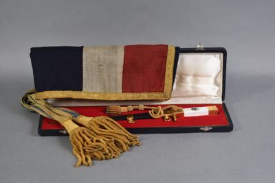 a small case with a tie and a belt in it