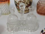 many glass vases on a white table with a vase in the background
