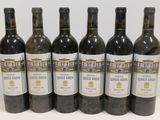 six bottles of wine are lined up in a row on a table