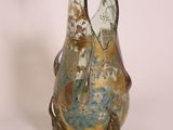 a glass vase with a dragon on it sitting on a table