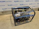 a small generator sitting on the ground in front of a wall