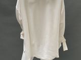 a mannequin wearing a white shirt and white pants