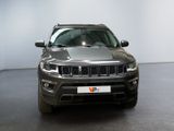 the jeep compass is parked in a showroom with a white wall