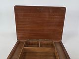 a small wooden box with compartments inside of it